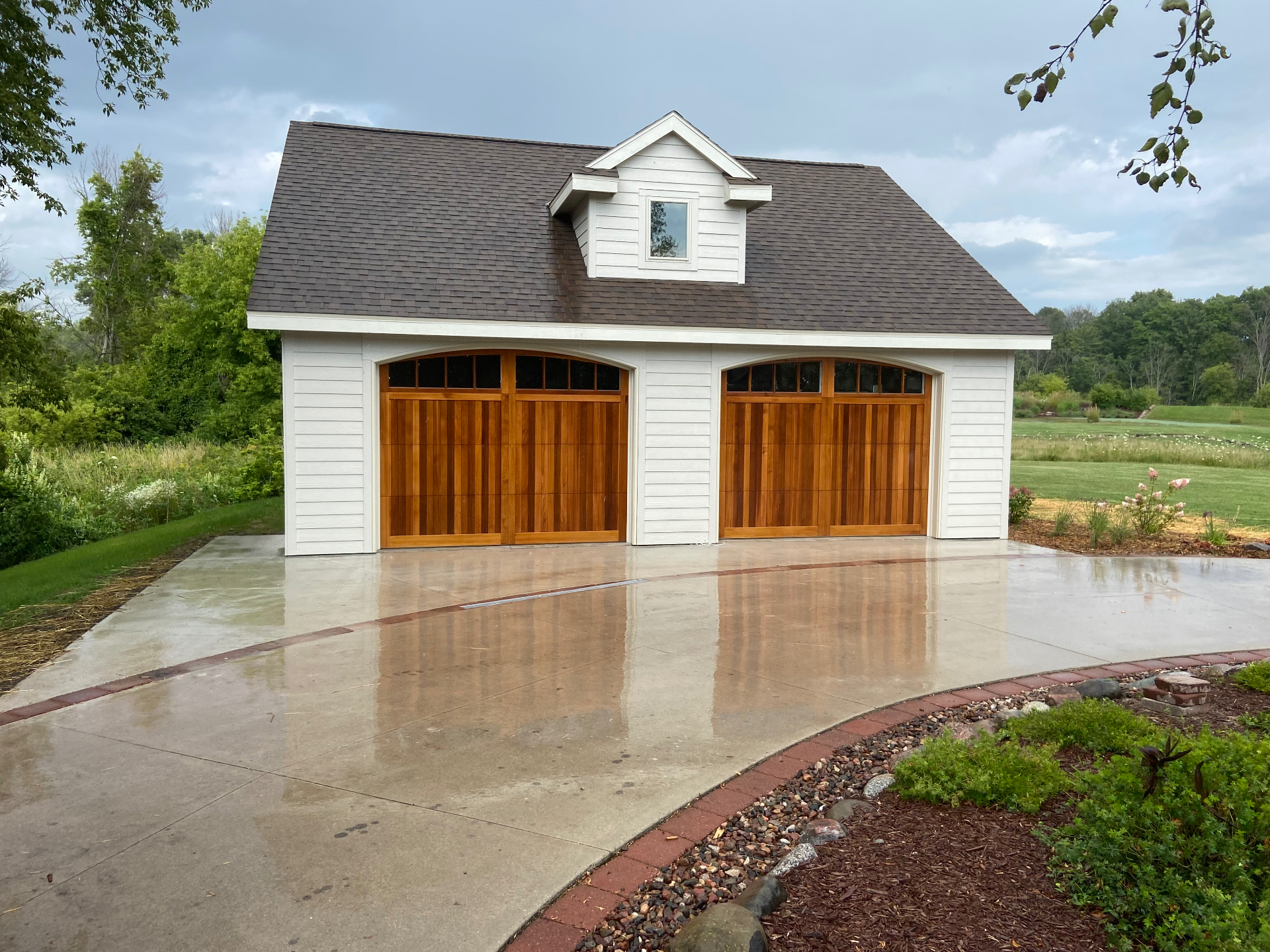 Custom detached two-car garage with cedar carriage-style doors
